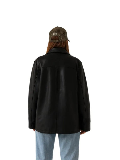 Women’s 90s style vintage oversized black leather long jacket with straight fit silhouette.