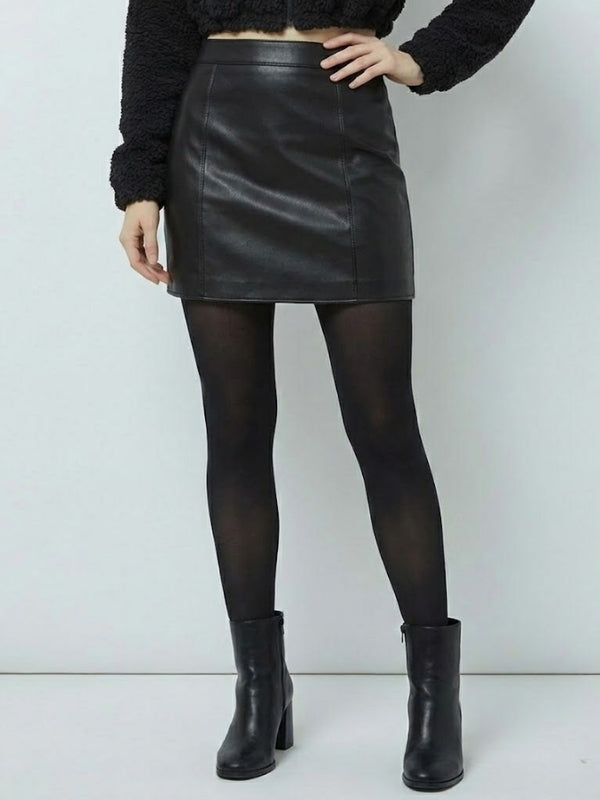 Person wearing a black leather skirt, black tights, and black boots on a white background