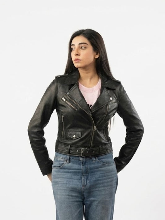 Woman wearing a black leather jacket and blue jeans on a white background