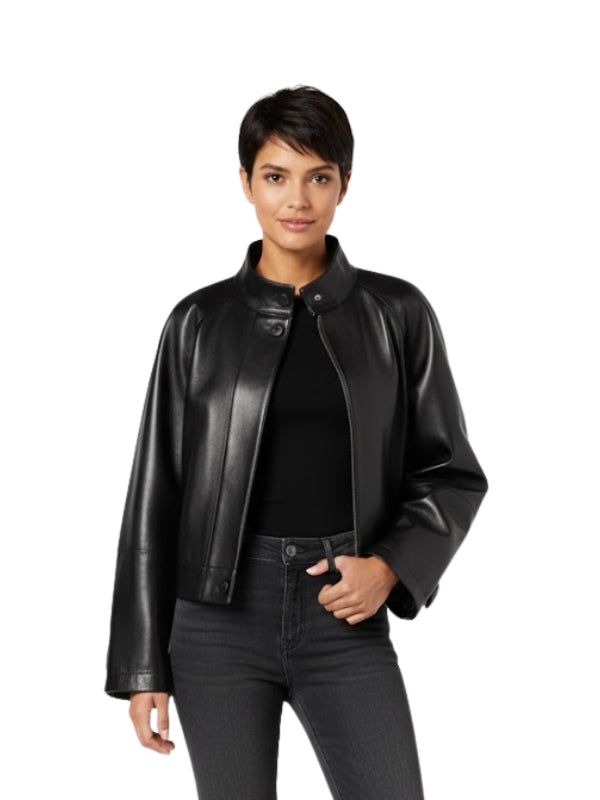 Woman wearing a black leather jacket and jeans on a white background