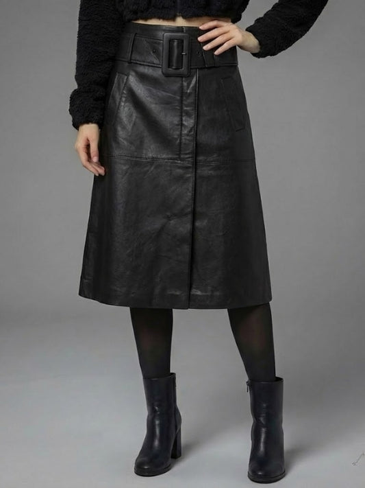 Person wearing a black leather skirt with a belt on a gray background