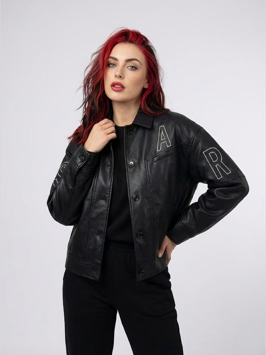 Woman wearing a black leather jacket with 'A' and 'R' patches on a white background