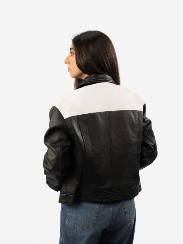 Person wearing a black and white jacket on a white background