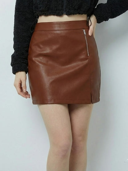 Brown leather skirt worn by a person on a white background