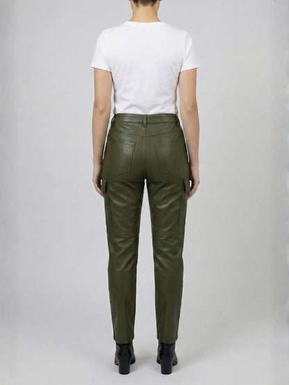 Person wearing green leather pants on a plain background