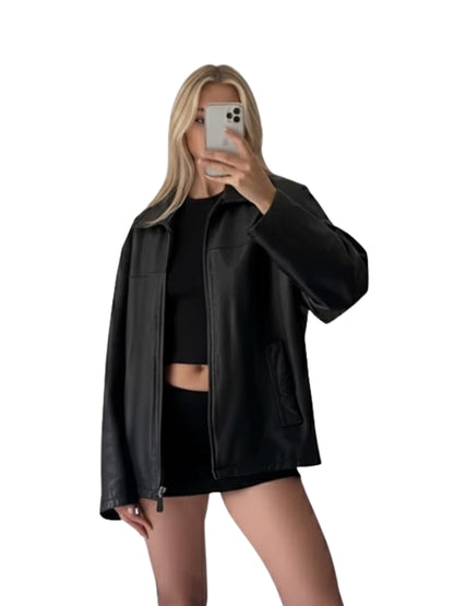 Person wearing a black leather jacket and black outfit on a white background