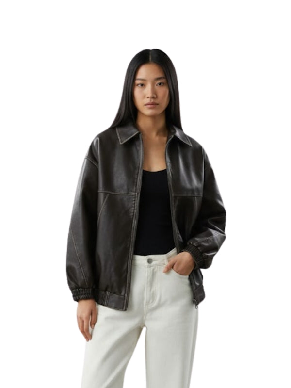Woman wearing a black leather jacket and white pants on a white background