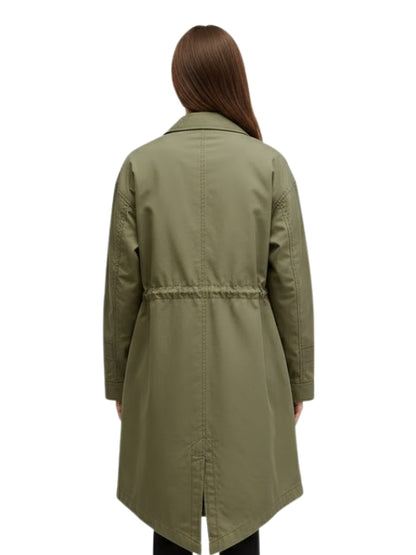 Person wearing a green trench coat on a white background
