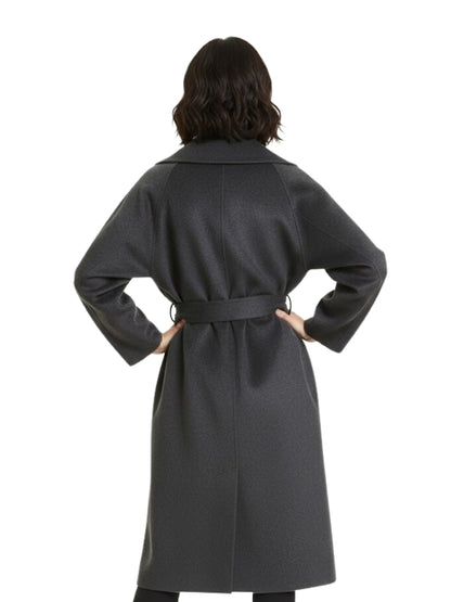 Person wearing a gray coat with a belt on a white background