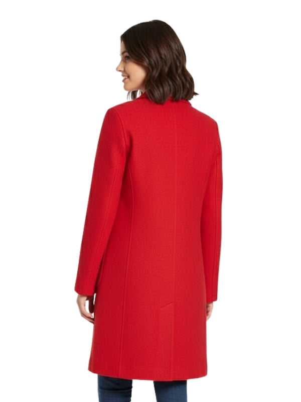 Woman wearing a red coat on a white background