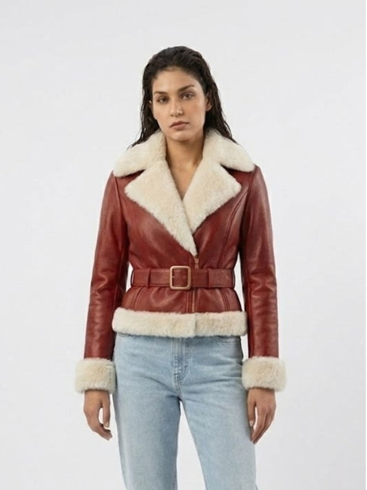 Woman wearing a red leather jacket with white fur trim on a white background