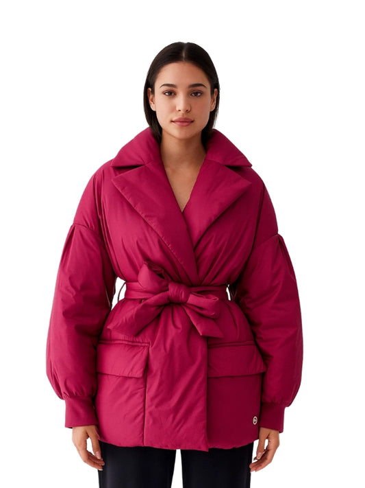 Woman wearing a pink jacket on a white background