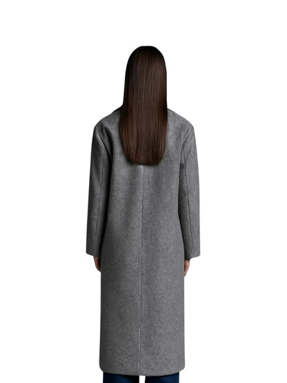Person wearing a gray coat from behind on a white background