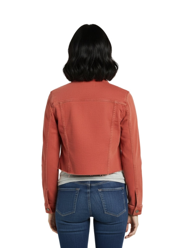 Person wearing a rust-colored jacket and blue jeans on a white background