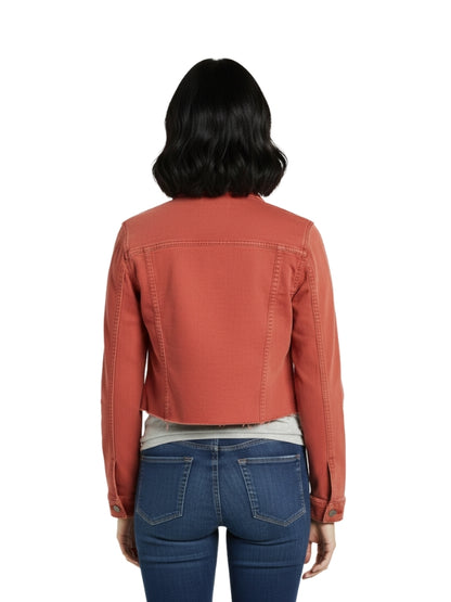 Person wearing a rust-colored jacket and blue jeans on a white background