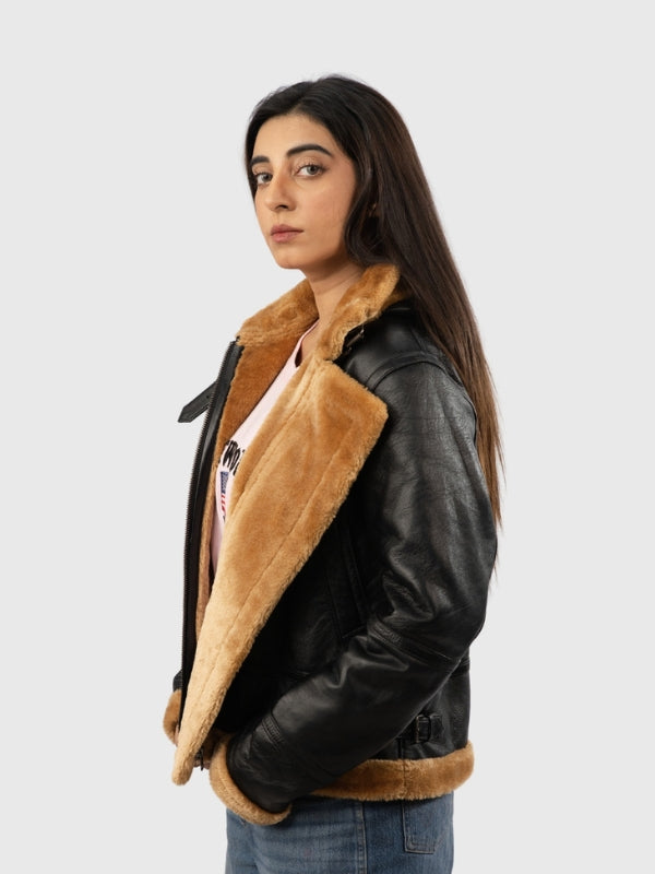 Person wearing a black leather jacket with brown fur lining on a white background