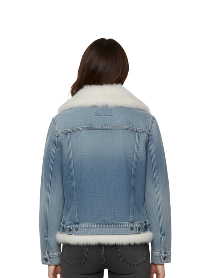 Blue denim jacket with white fur trim worn by a person on a white background