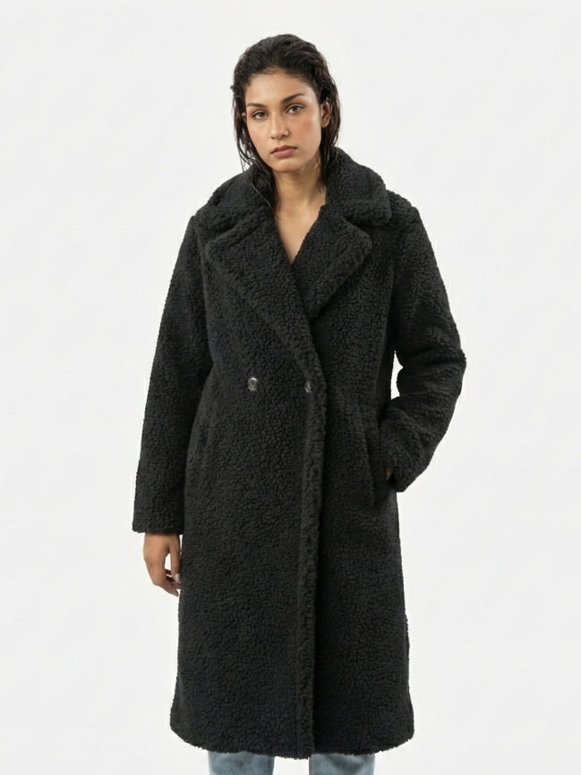 Woman wearing a black coat on a white background