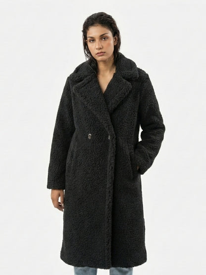 Woman wearing a black coat on a white background