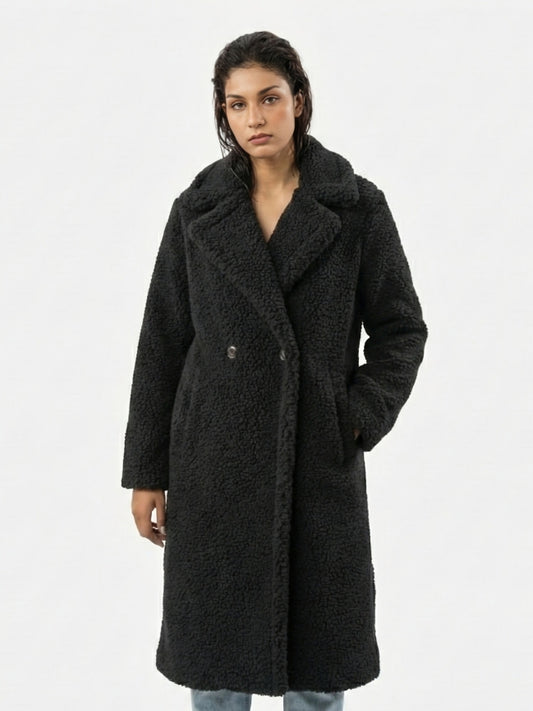 Woman wearing a black coat on a white background