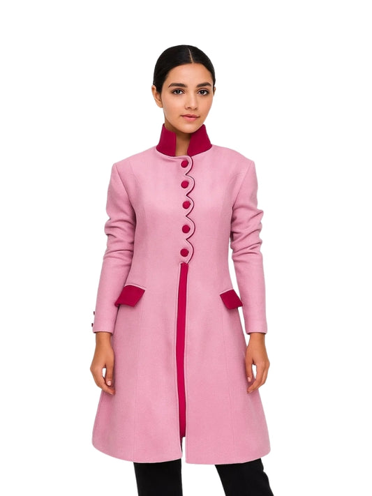 Pink coat with red accents worn by a model on a white background