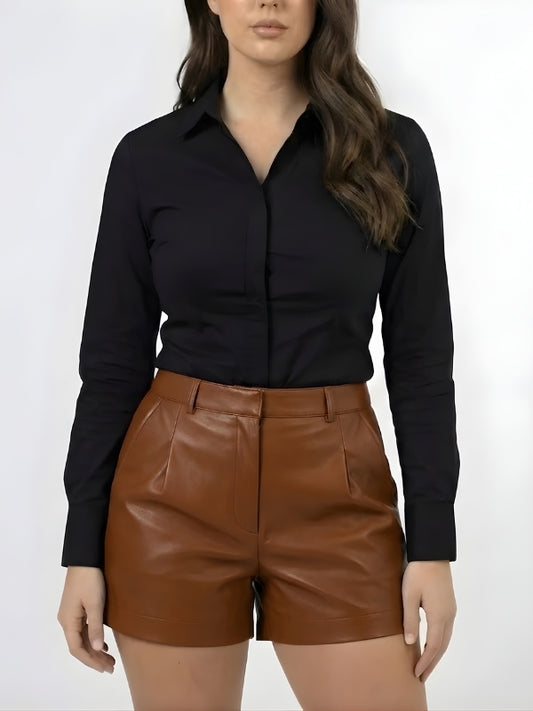 Person wearing a black shirt and brown leather shorts on a white background