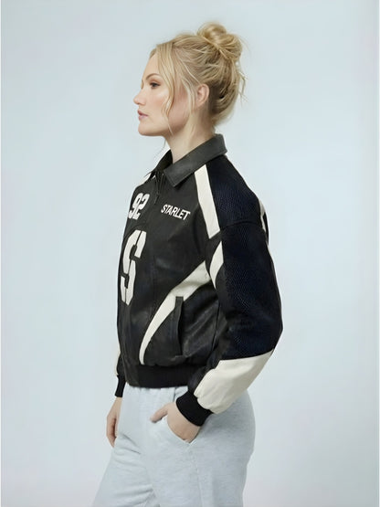 Woman wearing a black and white jacket with visible branding on a light gray background