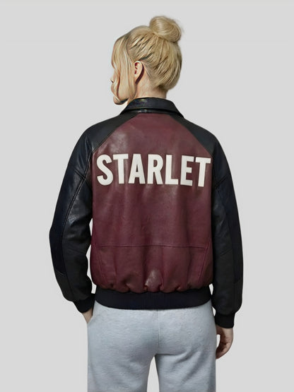 Person wearing a maroon and black jacket with 'STARLET' on the back against a plain background