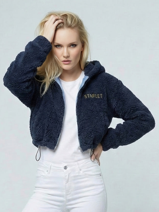 Woman wearing a navy blue fleece jacket with 'STARLET' branding on a light gray background