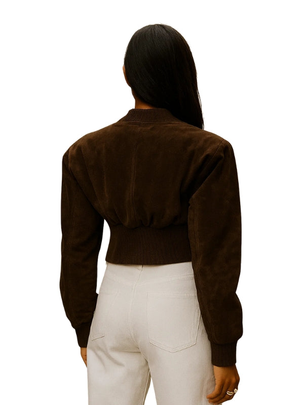 Person wearing a brown jacket and white pants on a white background