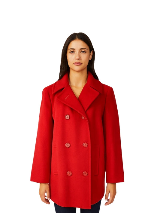 Woman wearing a red coat on a white background