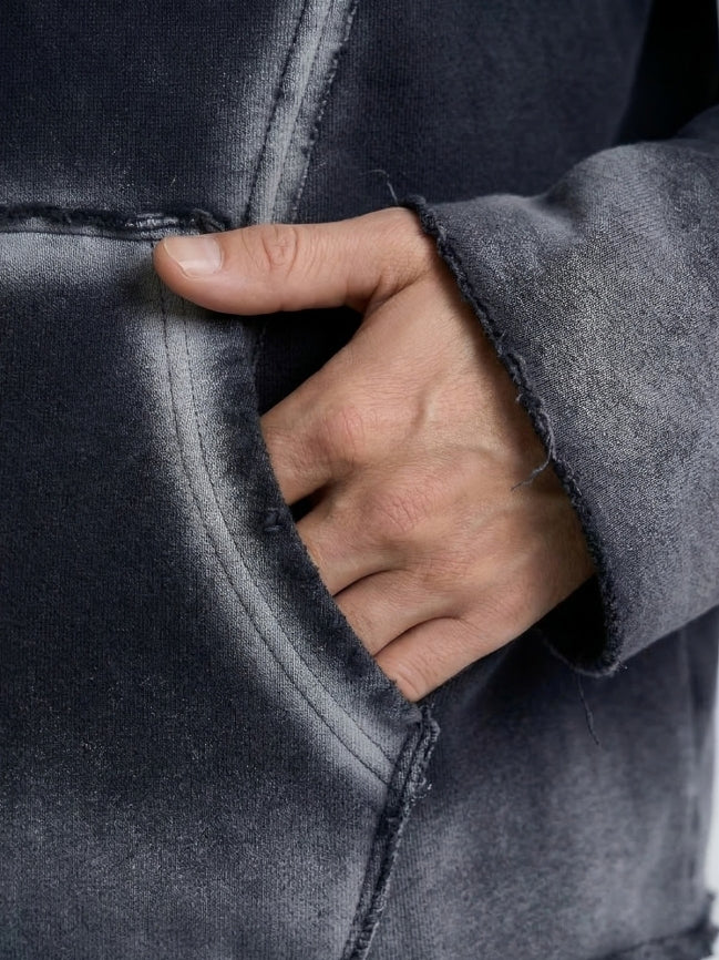 Hand peeking out from a dark gray jacket with a close-up view.