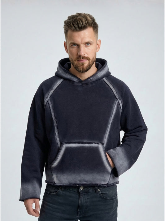 Man wearing a dark gray hoodie with a light gray gradient on a light gray background